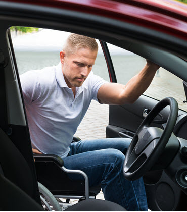 man entering vehicle in wheelchair